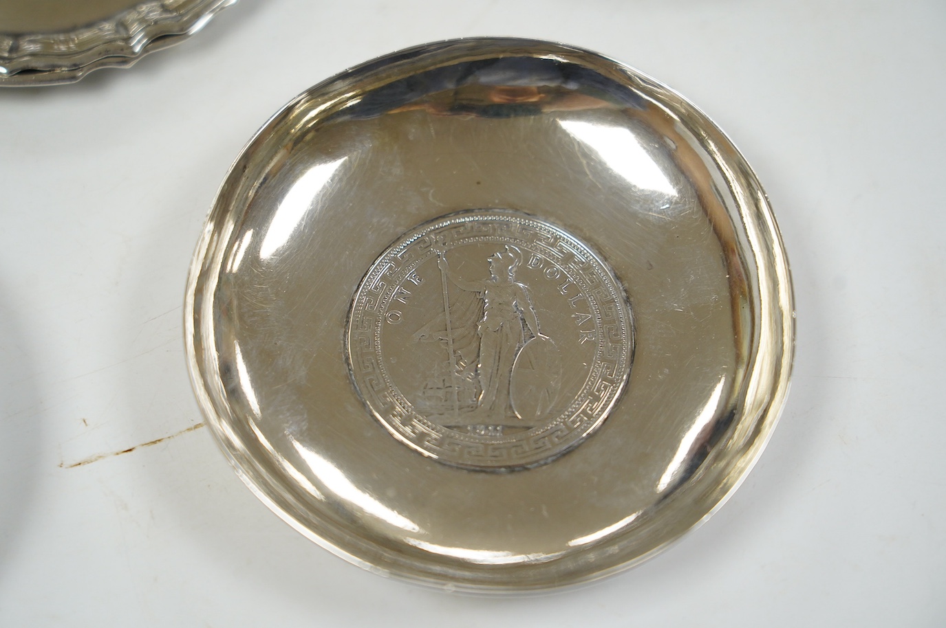 A pair of George V silver pedestal bonbon dishes, Birmingham, 1916, diameter 12.7cm, a set of four similar silver glass coasters, a silver bonbon bowl and a pair of Chinese white metal dishes with inset coin bases by Wan